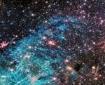 A James Webb Telescope image of the center of the Milky Way showing intersecting red stars and blue filaments of gas.