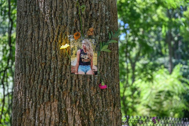 A photo of Rachel Morin along the Ma & Pa trail during the memorial walk Saturday morning decorated with flowers.